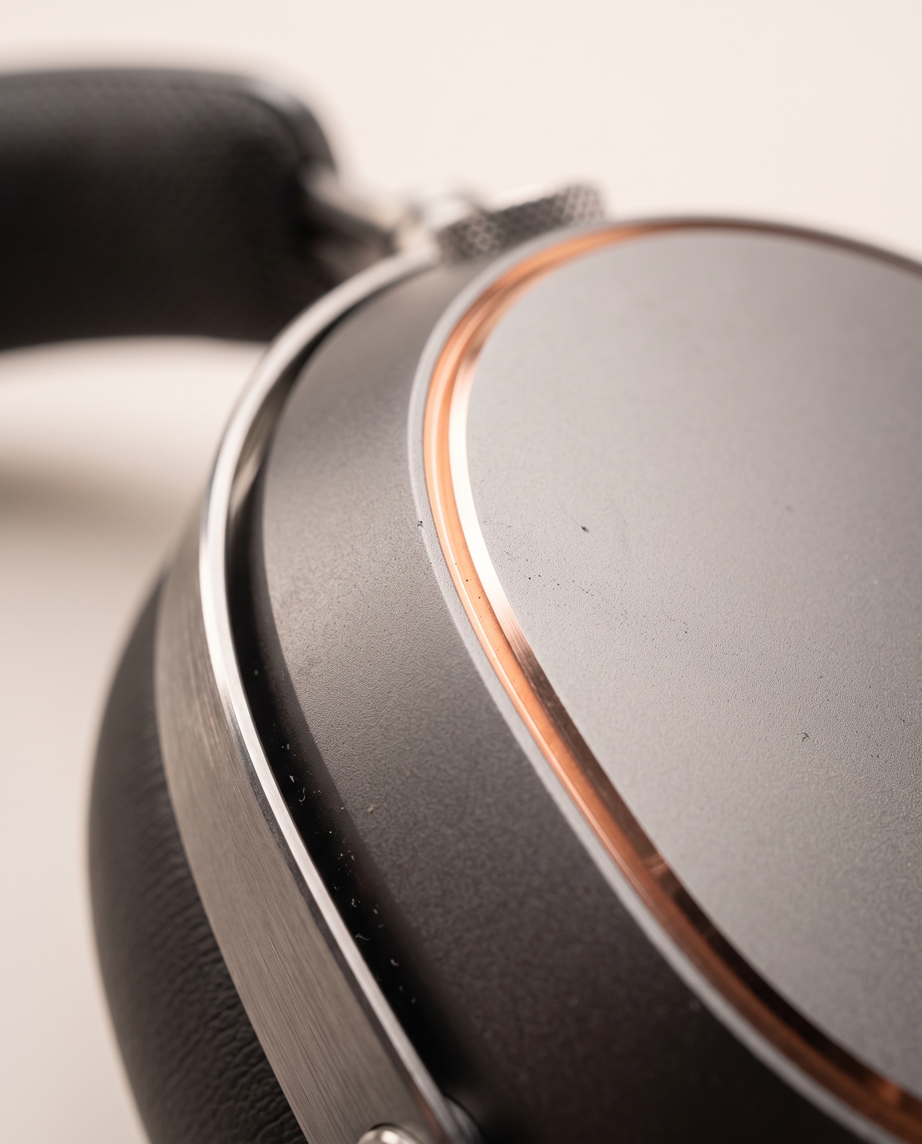 Macro view of a graphite aluminum earcup meeting its polished copper chamfer