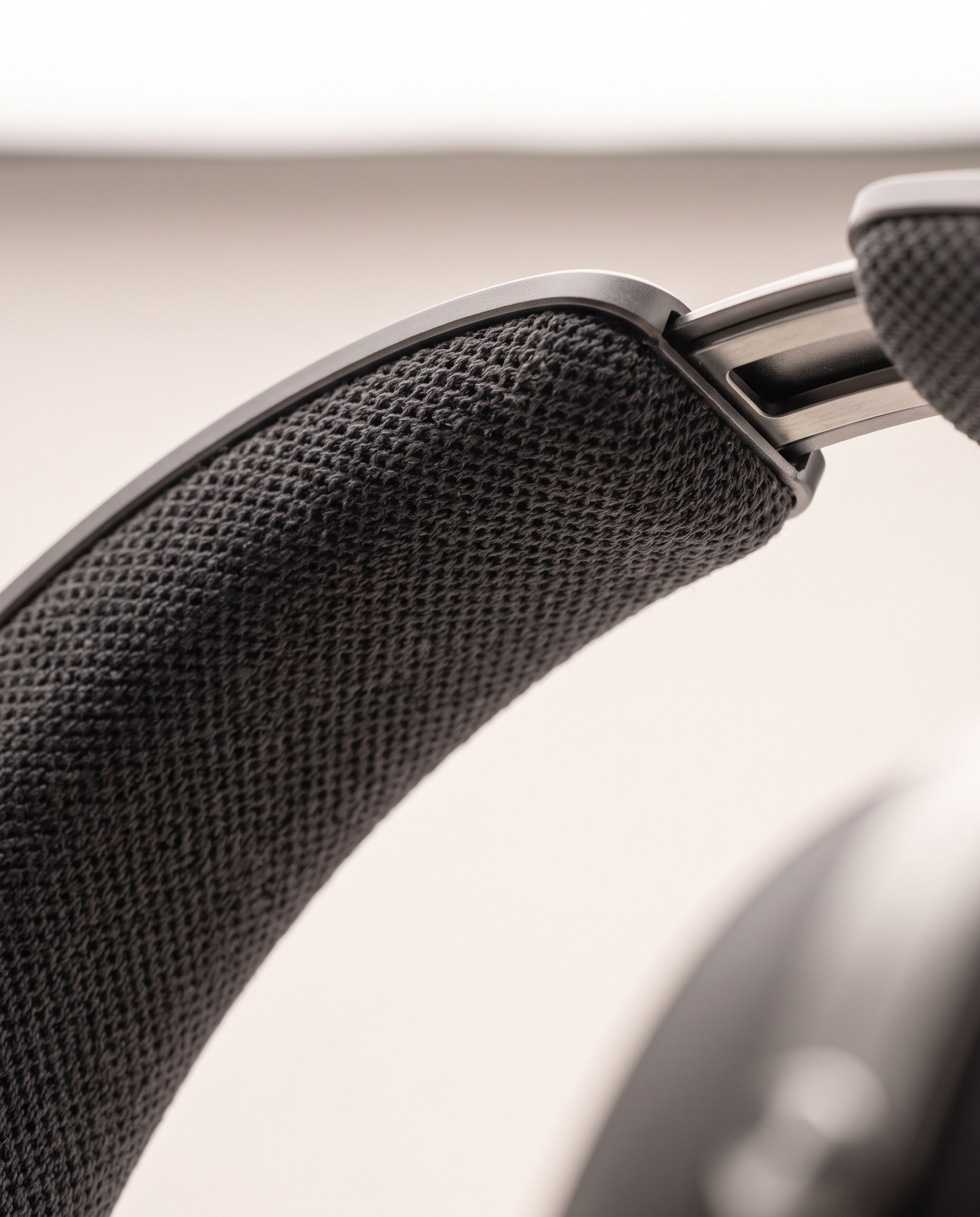 Close-up of the dark knit canopy beneath the aluminum headband