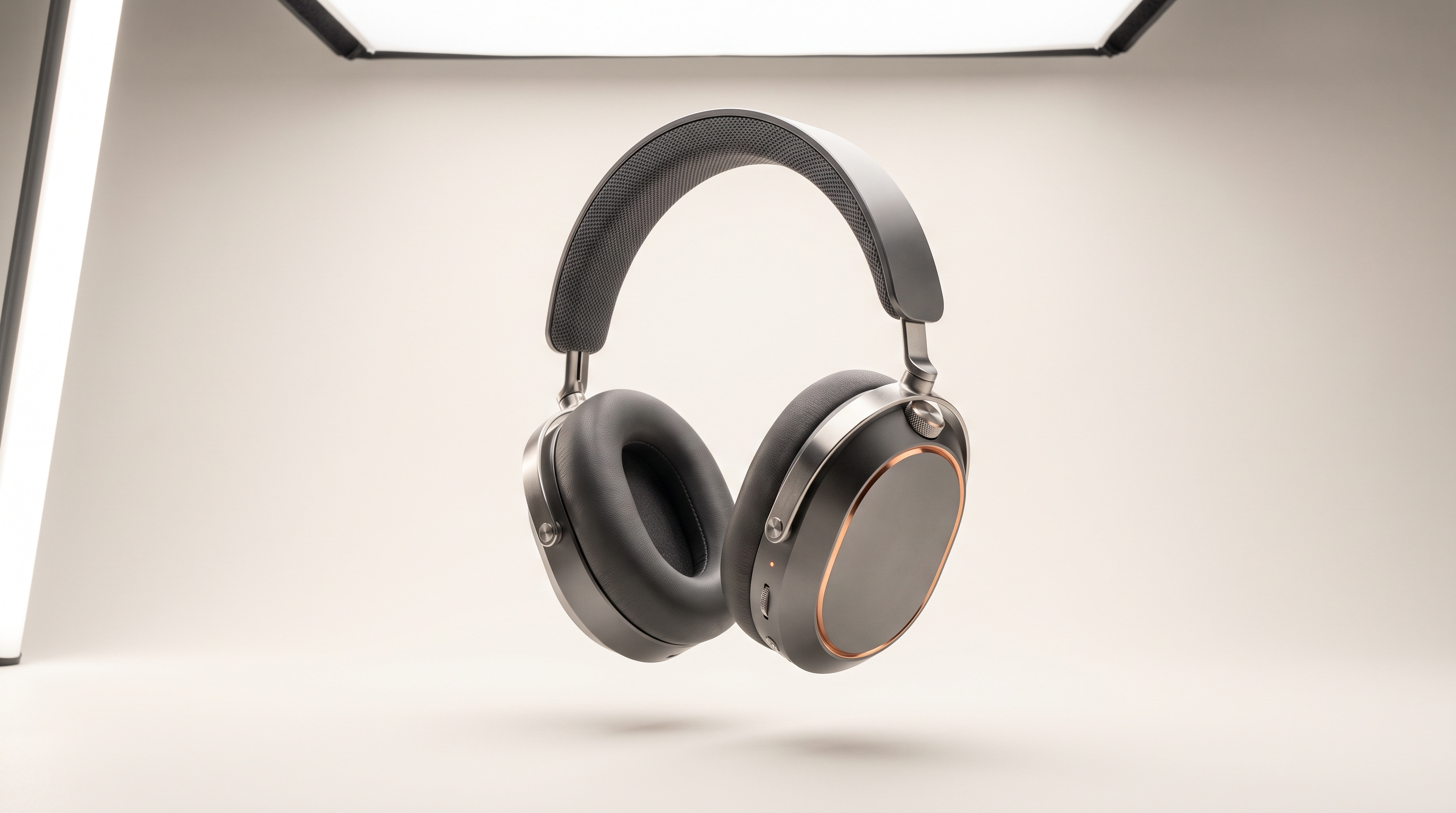 Onde One headphones floating in a photo studio, graphite earcups framed by copper chamfers